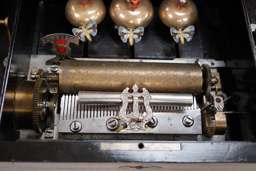 A 19th century Swiss cylinder music box, in a walnut and kingwood cross banded case, with 43 tooth cylinder (missing one tooth), and three bells with butterfly hammers, playing eight airs, cylinder 15.5cm long, case 48cm